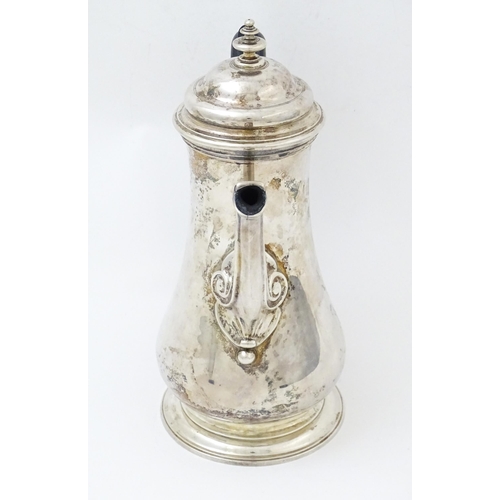 653 - A Geo II silver coffee pot hallmarked London c. 
1752, maker Thomas Whipham. Approx. 8 1/2