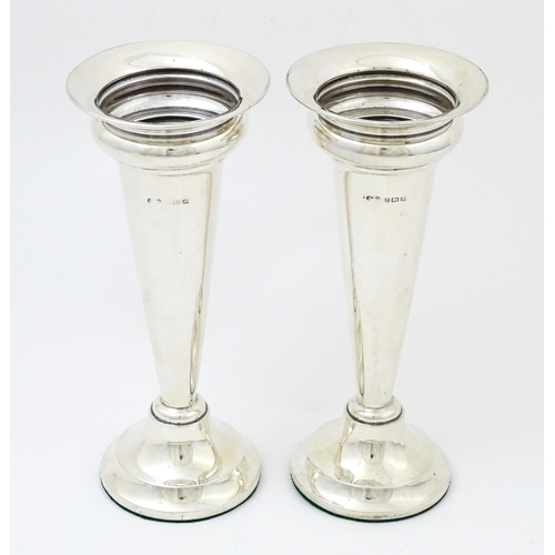 654 - A pair of silver vases hallmarked Birmingham 1927, maker Deakin & Francis. Approx. 7