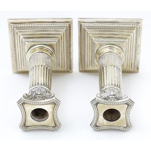 657 - A pair silver candlesticks of Corinthian column form with squared stepped bases, hallmarked Sheffiel... 