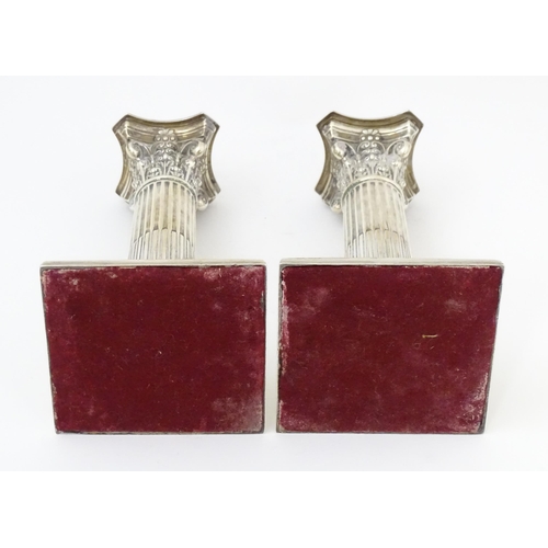 657 - A pair silver candlesticks of Corinthian column form with squared stepped bases, hallmarked Sheffiel... 