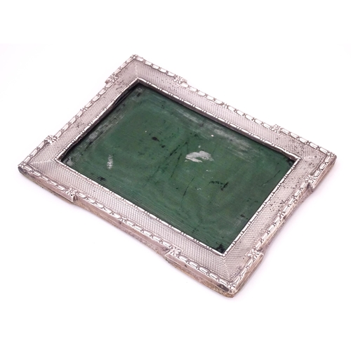 666 - A photograph frame with silver surround with engine turned decoration, hallmarked Sheffield 1913, ma... 