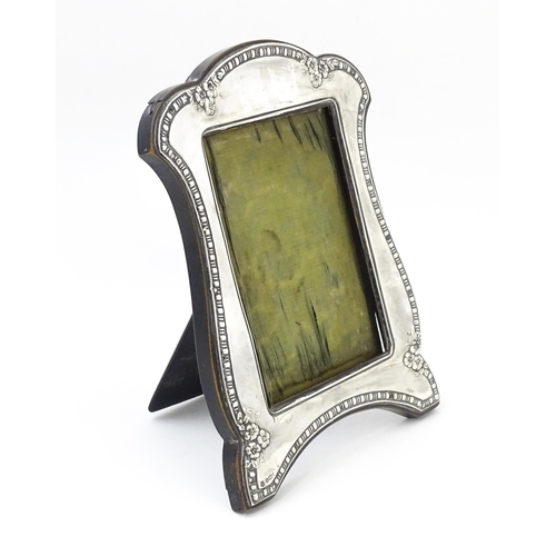 667 - An easel back photograph frame with silver surround hallmarked Birmingham 1910, maker James Deakin &... 