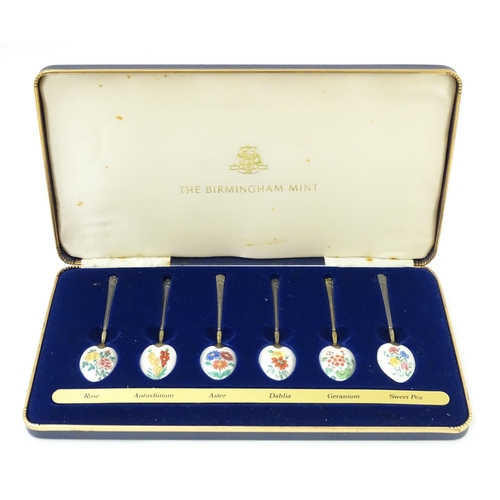 670 - A cased set of six silver gilt teaspoons, the bowl backs with enamel decoration depicting various fl... 