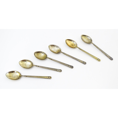 670 - A cased set of six silver gilt teaspoons, the bowl backs with enamel decoration depicting various fl... 