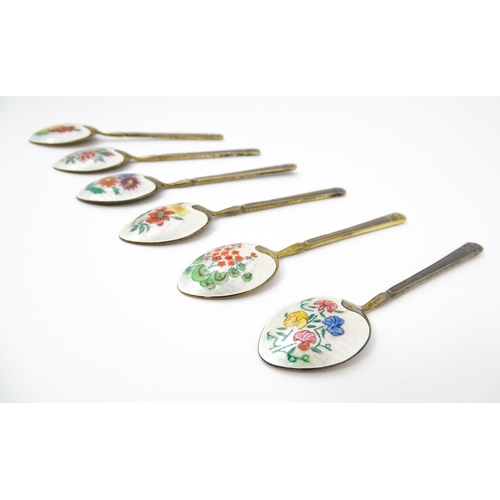 670 - A cased set of six silver gilt teaspoons, the bowl backs with enamel decoration depicting various fl... 