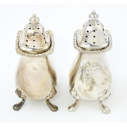 671 - A silver five piece cruet set comprising two salts, two peppers, a mustard pot, and spoons hallmarke... 