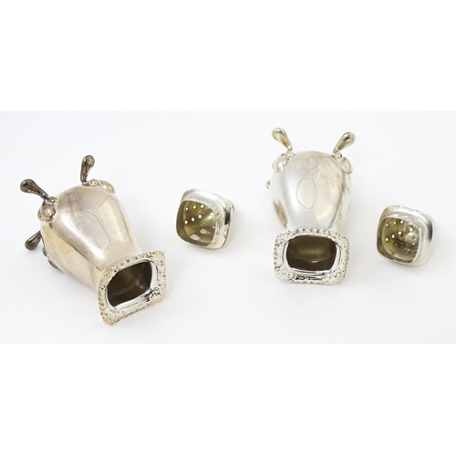 671 - A silver five piece cruet set comprising two salts, two peppers, a mustard pot, and spoons hallmarke... 