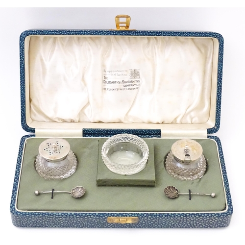 672 - A silver and cut glass three piece cruet set comprising salt, pepper and mustard, hallmarked Birming... 