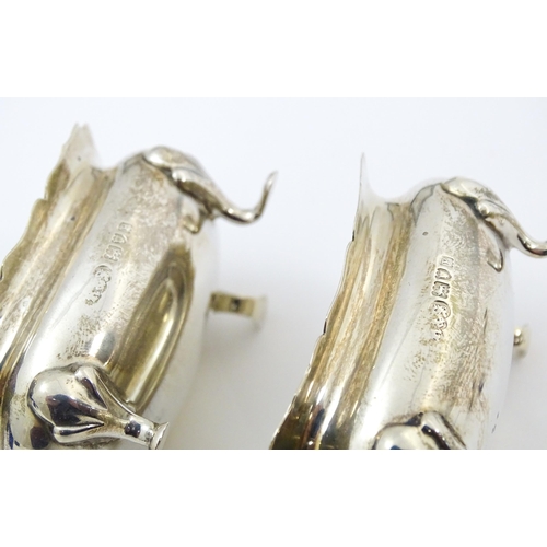 674 - A cased pair of silver salts with blue glass liners, hallmarked London 1910, maker Reid & Sons. With... 