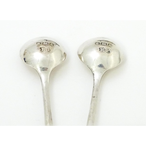 674 - A cased pair of silver salts with blue glass liners, hallmarked London 1910, maker Reid & Sons. With... 