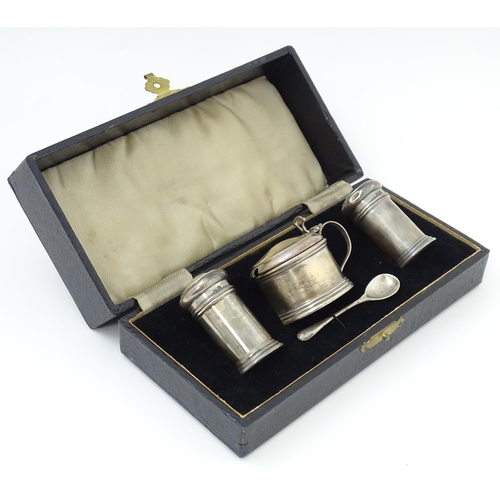 675 - A silver three piece cruet set comprising salt, pepper and mustard with spoon, hallmarked Birmingham... 