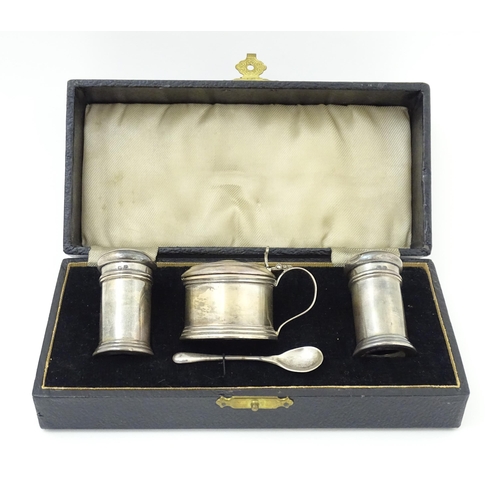 675 - A silver three piece cruet set comprising salt, pepper and mustard with spoon, hallmarked Birmingham... 