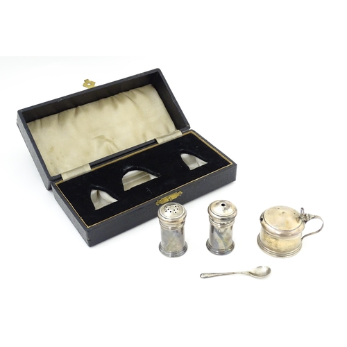 675 - A silver three piece cruet set comprising salt, pepper and mustard with spoon, hallmarked Birmingham... 