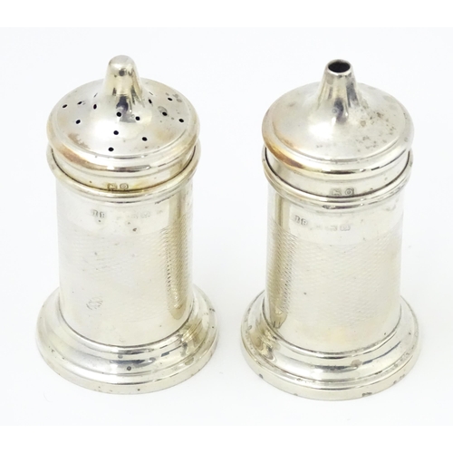 676 - An Art Deco silver three piece cruet set comprising salt, pepper and mustard pot, hallmarked Birming... 