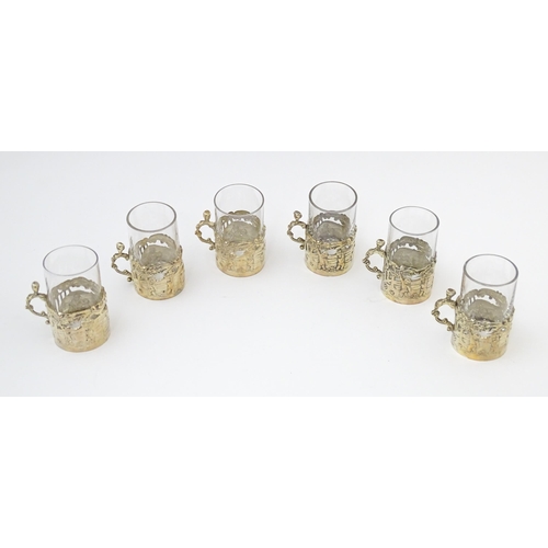 680 - A cased set of six tot glasses with silver holders hallmarked Birmingham 1911, maker William Comyns ... 