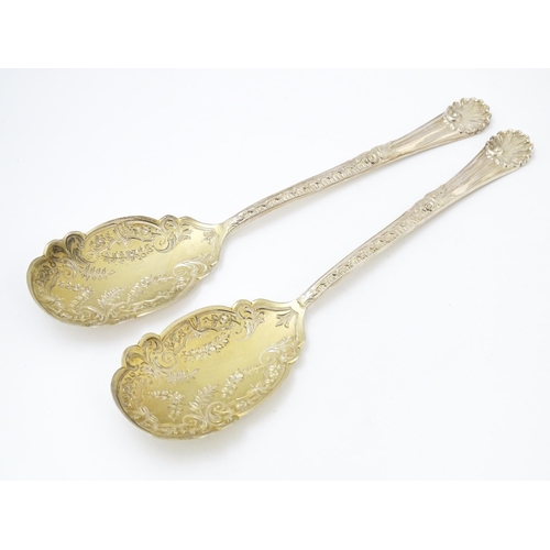 683 - A pair of Victorian silver serving spoons with gilt bowls, hallmarked Sheffield 1899, maker Walker &... 