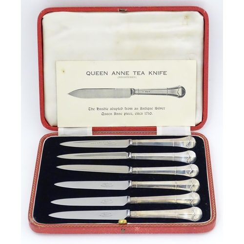 690 - A cased set of six silver handled tea knives titled The Queen Anne Tea Knife (The handle adapted fro... 