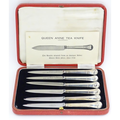 690 - A cased set of six silver handled tea knives titled The Queen Anne Tea Knife (The handle adapted fro... 