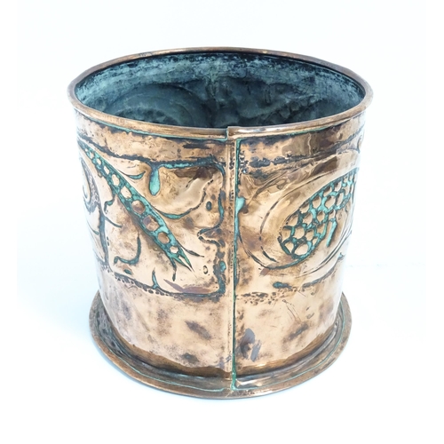 1062 - An Arts & Crafts copper jardiniere with embossed banded decoration depicting stylised scrolling foli... 