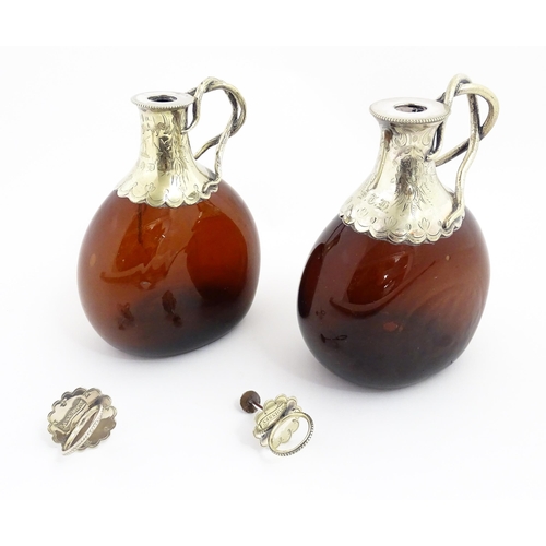 273 - Two Victorian whiskey flasks / spirit flagons, the brown amber glass bottles with silver plate mount... 