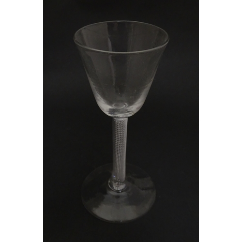 277 - A 19thC pedestal cordial glass with air twist stem.  Approx 6 1/2