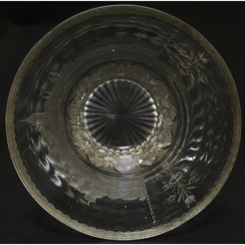 279 - A Continental drinking glass with cut decoration and etched scene depicting a Continental town lands... 