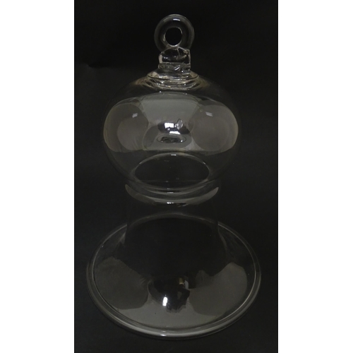 281 - A 19thC glass bell formed cover / cloche with folded foot base. Approx 8 1/2