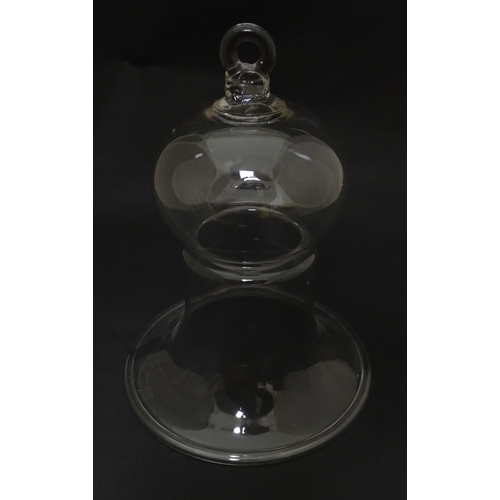 281 - A 19thC glass bell formed cover / cloche with folded foot base. Approx 8 1/2