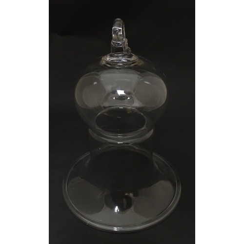 281 - A 19thC glass bell formed cover / cloche with folded foot base. Approx 8 1/2