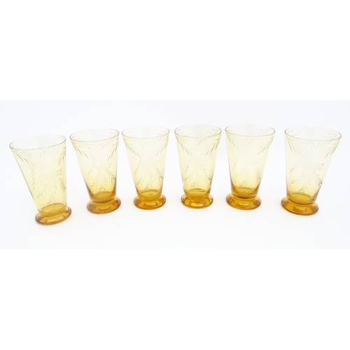 315 - An amber glass lemonade set comprising jug and 6 glasses with foliate decoration  lemonade set. the ... 