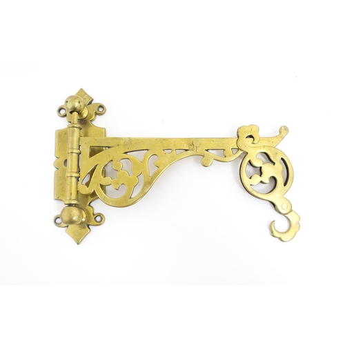 1186 - A late 19th / early 20thC brass firestick bracket with hook. Approx. 9 1/2