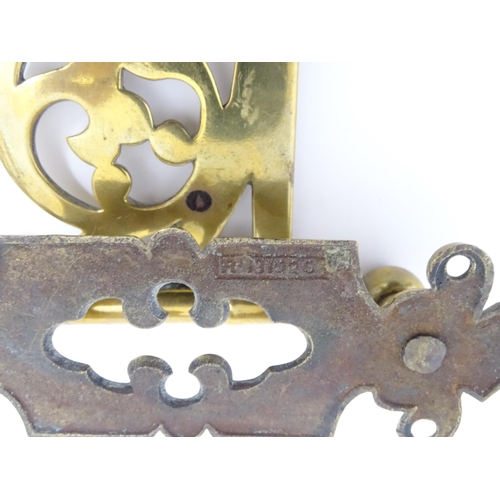 1186 - A late 19th / early 20thC brass firestick bracket with hook. Approx. 9 1/2