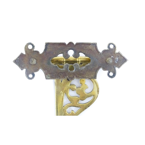 1186 - A late 19th / early 20thC brass firestick bracket with hook. Approx. 9 1/2