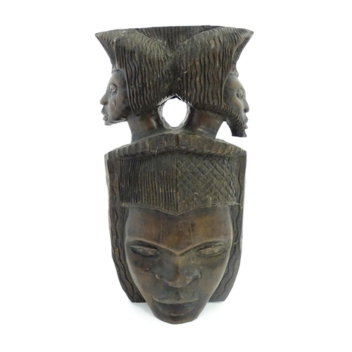 1189 - Ethnographic / Native / Tribal: An African hardwood carving depicting with a face surmounted by two ... 