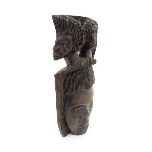 1189 - Ethnographic / Native / Tribal: An African hardwood carving depicting with a face surmounted by two ... 