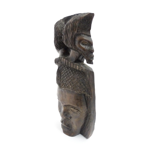 1189 - Ethnographic / Native / Tribal: An African hardwood carving depicting with a face surmounted by two ... 