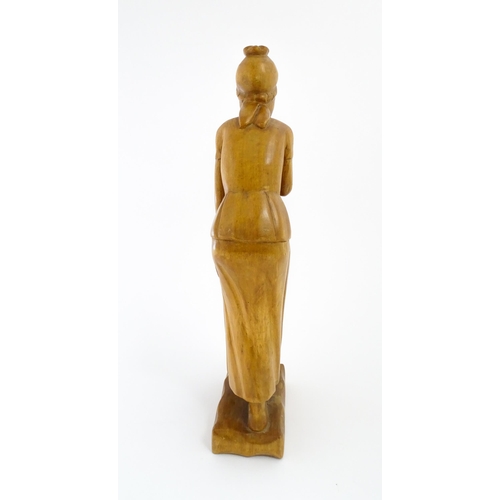 1193 - Ethnographic / Native / Tribal: An African carved wooden figure modelled as a female water carrier w... 