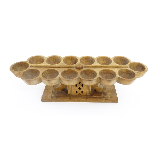 1197 - Ethnographic / Native / Tribal: An African Ashanti / Asante mancala games board raised on a carved a... 