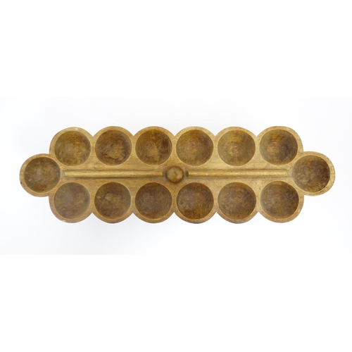 1197 - Ethnographic / Native / Tribal: An African Ashanti / Asante mancala games board raised on a carved a... 