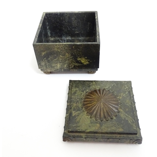 1233 - An Art Deco Ebena Bakelite box of squared form with floral motif to top. Marked under Made in Belgiu... 