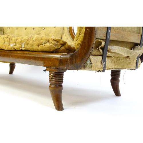 1822 - A Regency sofa frame with scrolled terminals and raised on four turned splayed feet. Deconstructed f... 