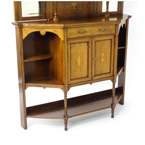 1825 - A Victorian rosewood chiffonier with a swans neck pediment above tiered shelves and mirrors, the str... 