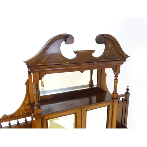 1825 - A Victorian rosewood chiffonier with a swans neck pediment above tiered shelves and mirrors, the str... 