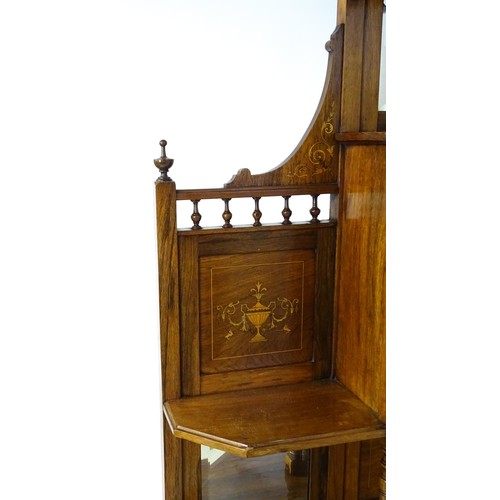 1825 - A Victorian rosewood chiffonier with a swans neck pediment above tiered shelves and mirrors, the str... 