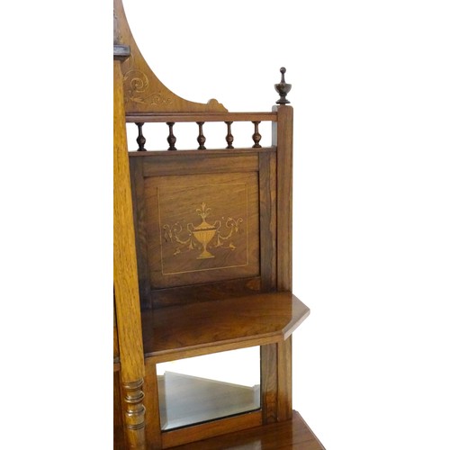 1825 - A Victorian rosewood chiffonier with a swans neck pediment above tiered shelves and mirrors, the str... 