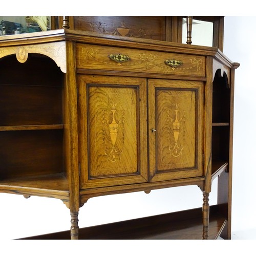 1825 - A Victorian rosewood chiffonier with a swans neck pediment above tiered shelves and mirrors, the str... 