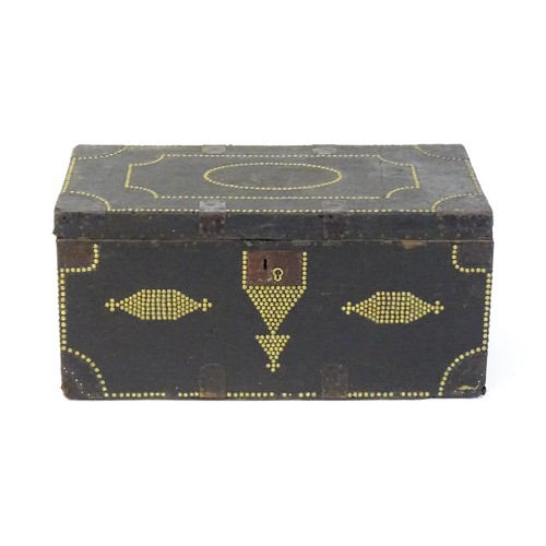 1865 - A 19thC trunk with a leather exterior and brass stud detailing, the chest flanked by wrought iron ca... 