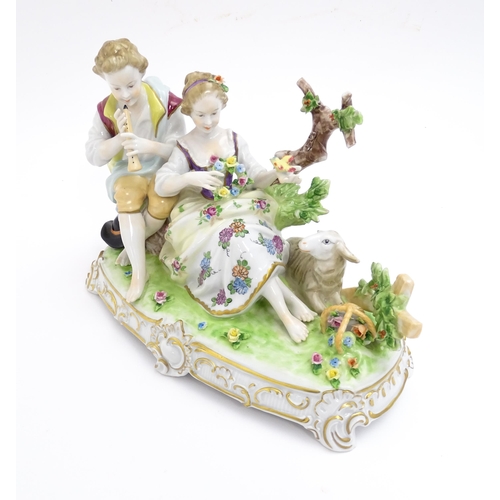 187 - A German figural group depicting shepherd and shepherdess with a lamb. Marked under. Approx. 6 3/4