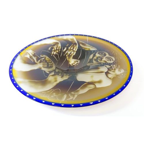 265 - Steven Newell  (b. 1948) :  A large American art glass dish / figural charger. The wrong hold,  with... 