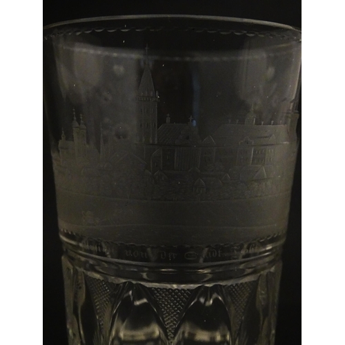 279 - A Continental drinking glass with cut decoration and etched scene depicting a Continental town lands... 